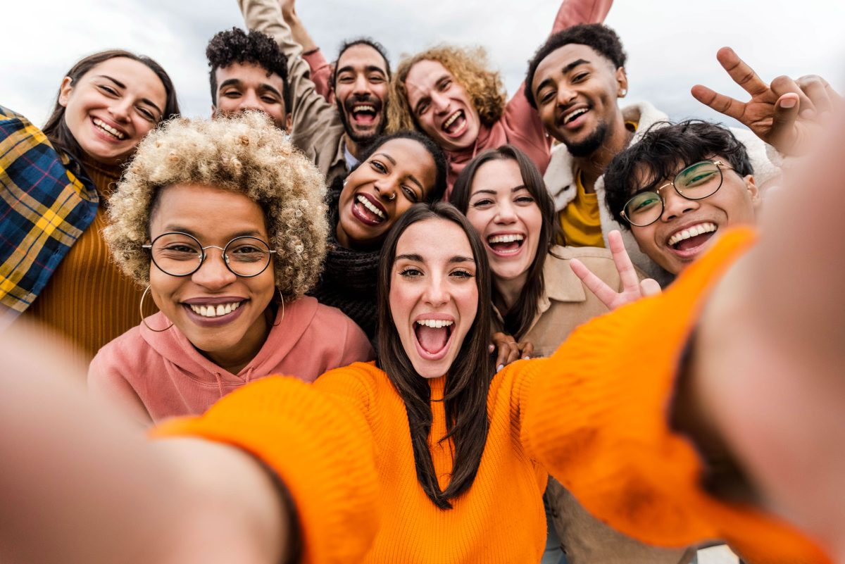 A group of friends smiling and taking a selfie