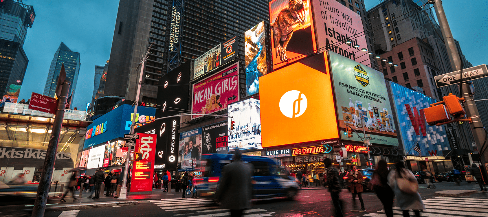 A wide shot of busy, downtown intersection