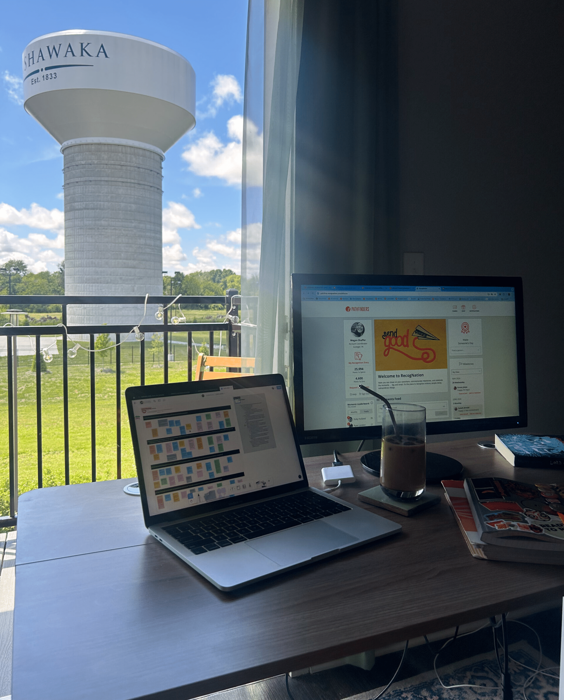 A Pathfinders' work from home setup, featuring a window and a water tower